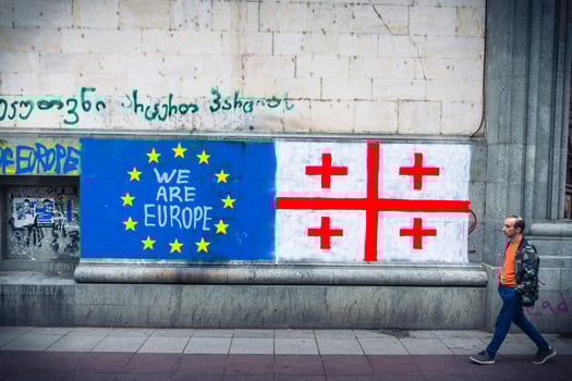 Tbilisi, Georgia - 16th may, 2024- Georgian flag lay on ground by written statement we need EU. Integration process to EU concept photo