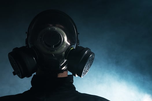 Man in Gas Mask Amidst Smoke photo