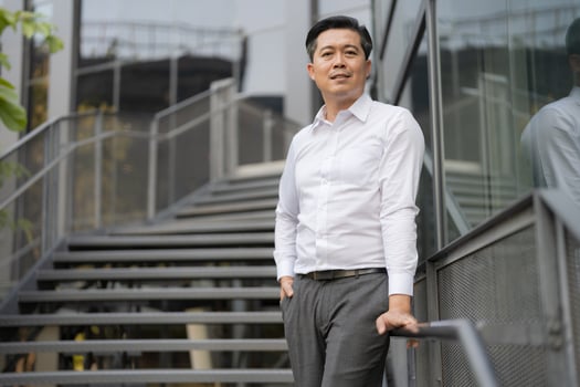 Confident businessman descending outdoor stairs photo