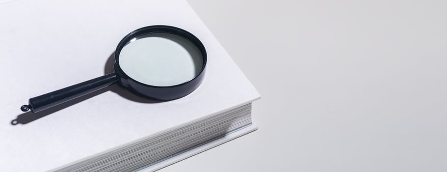 Office document magnification, magnifying glass on paper. Business concept with lens and book photo
