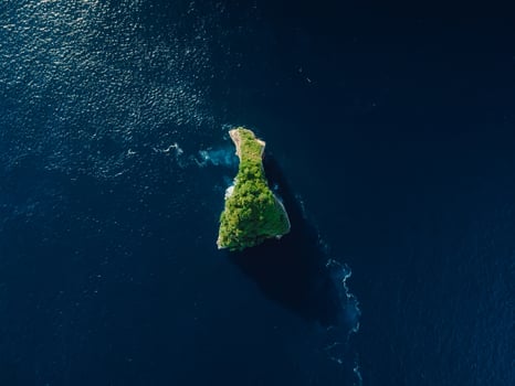 Alone scenic rock in ocean near Nusa Penida island. Aerial view photo