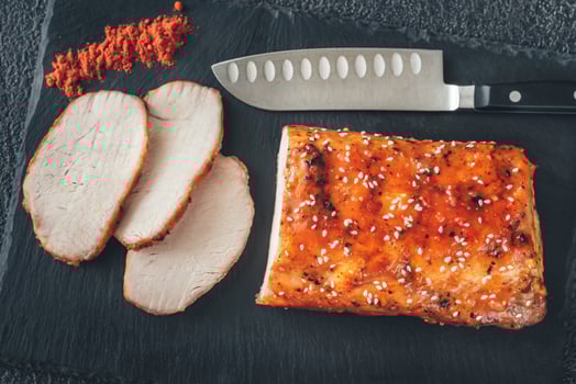 Baked meat with paprika on the black sone board photo