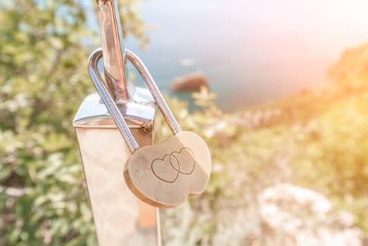 Wedding Heart Golden Lock on stainless iron fence. Valentine's day. Symbol of eternal love. A wedding tradition all over the world to hinder the lock. Monument on the wedding day. photo