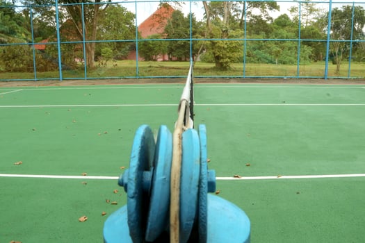 Tennis balls on green and red tennis court. Sporty lifestyle concept, photo