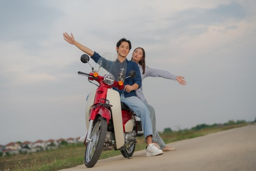 Young couple enjoying a motorcycle ride at dusk photo