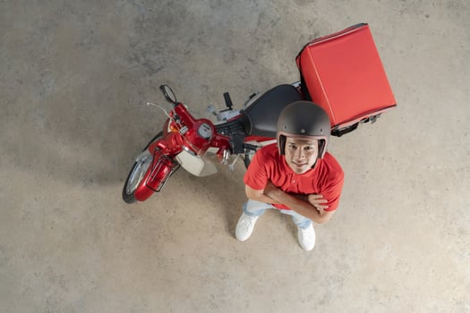 Delivery rider with red motorcycle ready for service photo