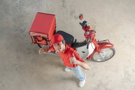 Delivery man with motorcycle giving thumb up photo