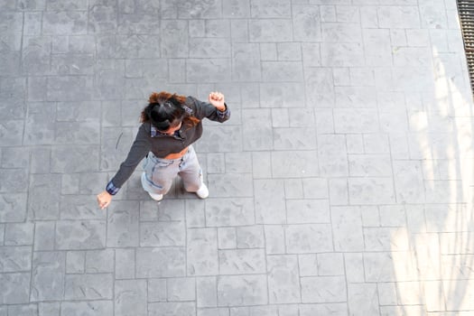 Asian women do freestyle hip hop and breakdancing in a public space in the middle of the city. With a cheerful and happy attitude photo