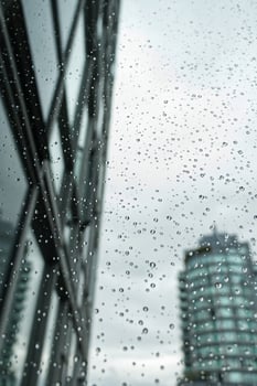 View from the window with water drops on it at rainy Day in Downtown Vancouver, British Columbia photo