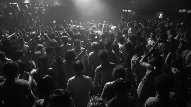 The loud bass and t drums reverberate through the packed nightclub as enthusiastic music fans lose themselves in the moment their movements freeing and uninhibited photo