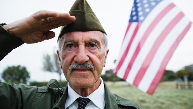 Veteran Salutes The American Flag On Memorial Day In The Cemetery Outdoor photo