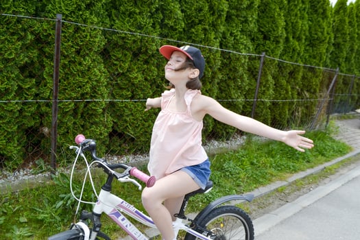 Young girl cyclist enjoy the beautiful sunrise on summer forest trail photo