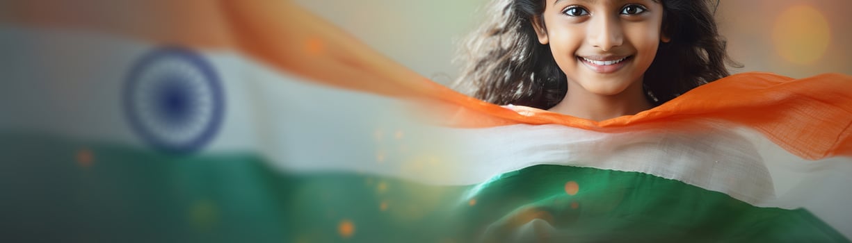 Happy, smiling Indian girl and blurred Indian flag, symbolizing patriotism and national pride. Celebrating Indian Independence Day. Love for the country. Panoramic banner. photo
