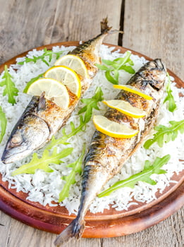 Grilled mackerel with basmati rice and fresh arugula photo