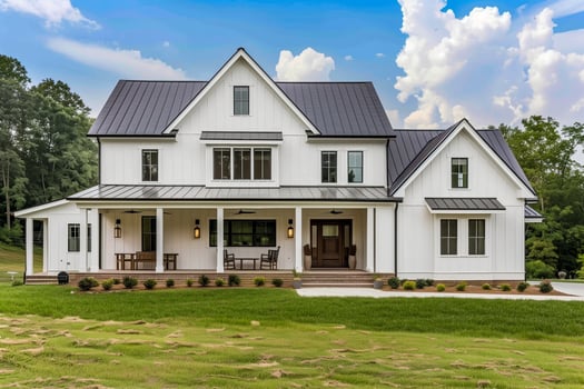 A white farmhouse with a black roof and a porch photo
