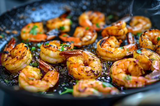Shrimp cooking in a skillet with lots of oil and herbs photo