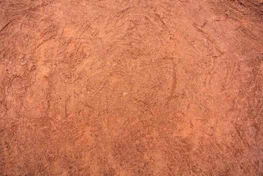Red Sandy Surface Imprinted with Shoe Tracks, Texture Background photo