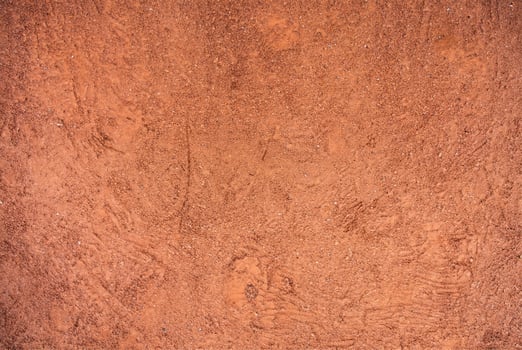 Red Sandy Surface Imprinted with Shoe Tracks, Texture Background photo