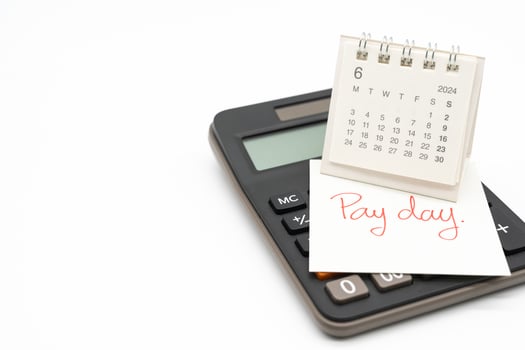 Hand writing text PAY DAY on June 2024 calendar with calculator in isolated background. Reminder concept of payment. copy space. photo