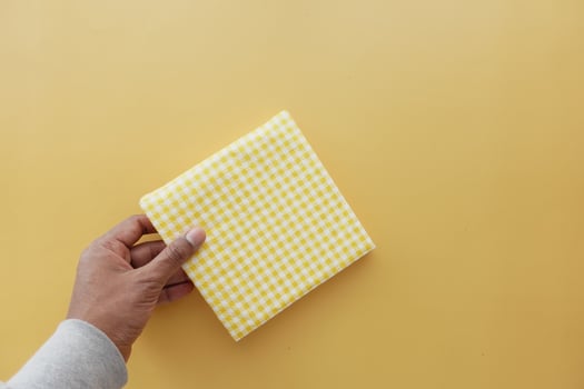 hand pull out a piece of yellow color tissue photo