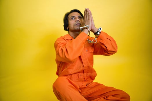 Prisoner man praying to god in handcuffed photo
