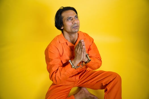Man sitting in hand join position photo