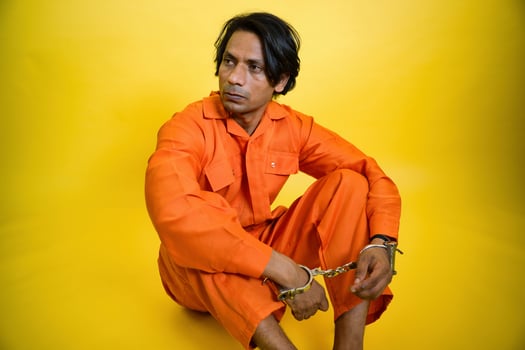Serious Man in Orange Jumpsuit photo