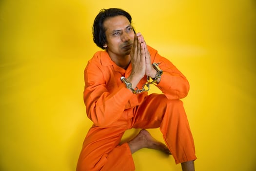 A prisoner apologizing with joining hand photo