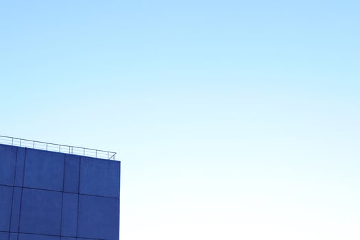 House Corner on Blue Sky Background photo