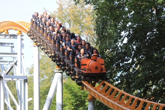 Swiftly descending down rollercoaster rail train with peoples. Amusement park Divo-island. Saint-Petersburg. photo