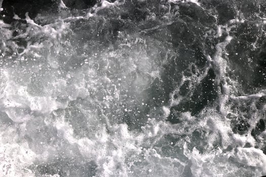Sea wave foam texture. Marine aqua motion surface background. Outdoor water froth swirls backdrop. photo