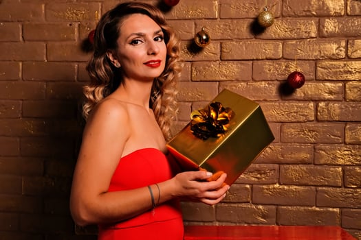 the girl received a gift. girl in a red dress. holiday gift. photo