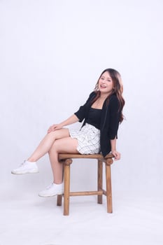 full body beautiful Asian girl 20s formal office elegant sexy cheerful smile sitting on wooden chair isolated white background photo