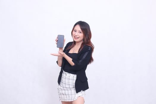 beautiful Indonesian office woman 20s cheerful smile expression promotion cellphone gadget screen hands welcome to promo isolated white background photo