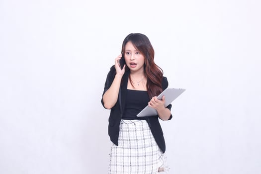 beautiful southeast asian girl 20s formal office shocked is calling her friend and bringing tablet for promo isolated white background photo
