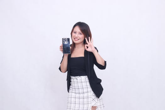 charm beautiful asian office girl 20s cheerful expression carrying cellphone gadget facing back while hand nice circular sign isolated white background photo