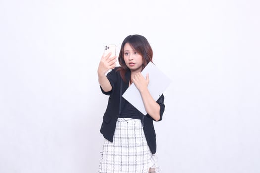 beautiful southeast asian woman 20s formal office flat smile looking at cellphone and carrying tablet for promo isolated white background photo