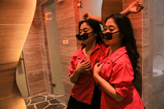 beauty of young asian woman wearing glasses candid sexy standing with her back and holding a large glass for health, fashion, science, knowledge content photo