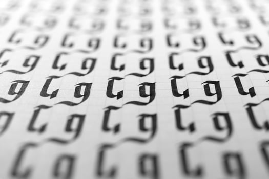 Calligraphy black and white letters G background. Lettering practice writing worksheet. Handwriting symbol filling pattern. Calligraphic letter G learning skills paper page. photo