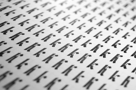 Calligraphy black and white letters K background. Lettering practice writing worksheet. Handwriting symbol filling pattern. Calligraphic letter K learning skills paper page. photo