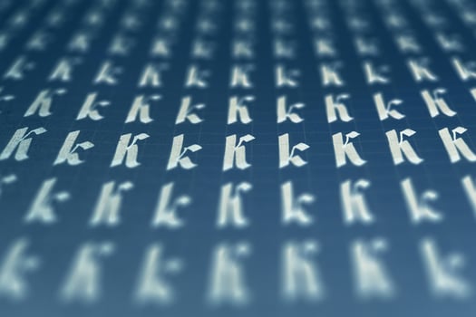 Lettering white on dark blue practice writing worksheet. Handwriting symbol filling pattern. Calligraphic letter K learning skills paper page. Calligraphy letters K background. photo
