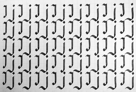 Handwriting black and white symbol filling pattern. Calligraphic letter J learning skills paper page. Calligraphy letters j background. Lettering practice writing worksheet. photo