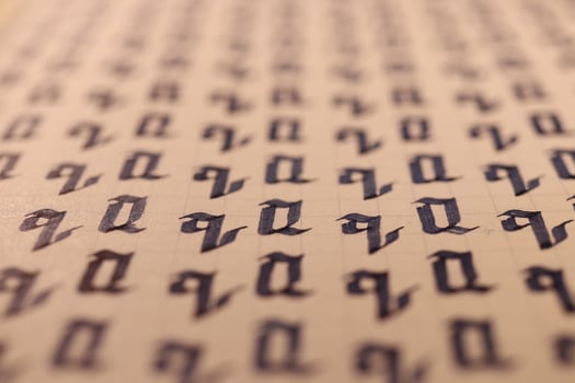 Lettering practice writing worksheet. Handwriting symbol filling pattern. Calligraphic letter Q learning skills paper page. Calligraphy letters q background. photo