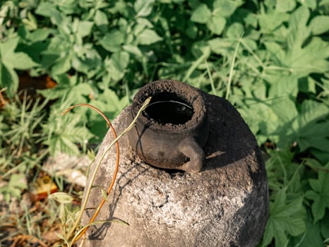 Pottery in the form of a small cup that was blackened from firing was on top of the stove photo