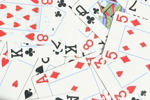 Assorted play cards backdrop. Many miscellaneous jumbled playing cards surface. Mixed playing cards background. photo