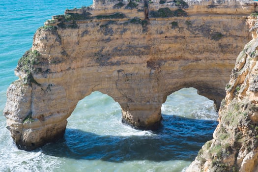 Natural arches at Praia da Marinha on the southern Algarve coast in Portugal photo