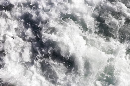 Sea wave foam texture. Marine aqua motion surface background. Outdoor water froth swirls backdrop. photo