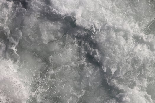 White marine aqua motion surface background. Sea wave foam texture. Outdoor water froth swirls backdrop. photo