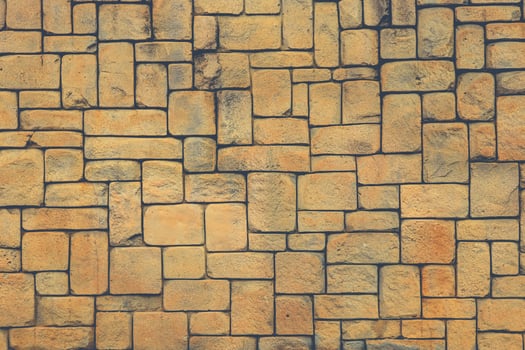 Masonry stone cladding wall texture. Geometric shapes surface background. photo