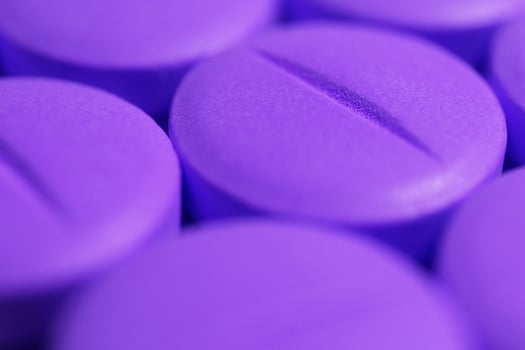 Purple Medicine Tablets. Pharmacy Pills Background. Macro Closeup. photo